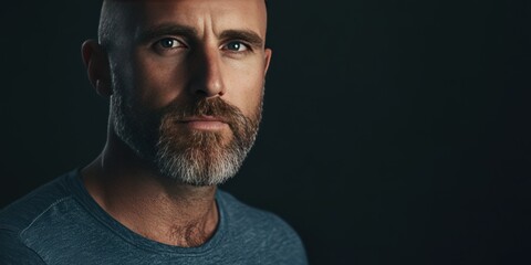 Intense Portrait of a Bearded Man with Deep Blue Eyes in Low Light