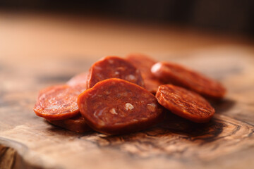 Slices of chorizo on olive wood board