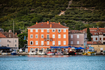 Beautiful, colorful houses in the small town of Cres, Croatia, built next to the sea shore with...