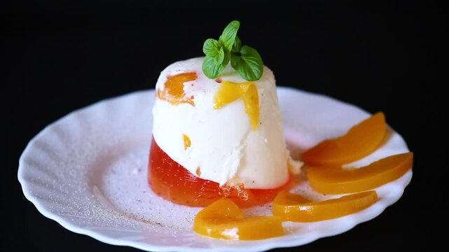 Portioned jelly dessert with yogurt cream and fruits.