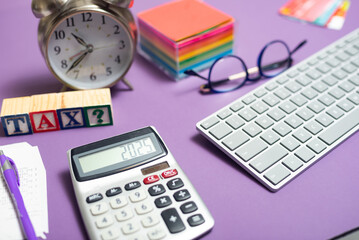 Tax season concept with a reminder of the deadline for filing tax deklorations. calculator on the table, background, concept of time to pay