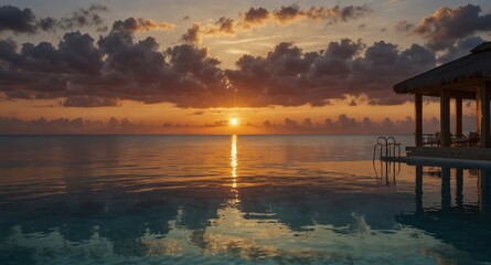 Ocean view at sunset with a calm sea and a charming gazebo, creating a picturesque tropical scene.