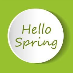 Spring greeting displayed on a circular white sign against a bright green background celebrating seasonal renewal