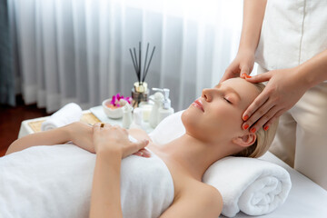 Caucasian woman enjoying relaxing anti-stress head massage and pampering facial beauty skin...
