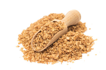 Buckwheat flakes in a wooden pot on a white background, healthy organic food concept