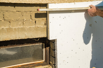 installing rigid styrofoam insulation board for energy saving of the house wall