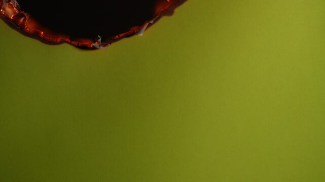 Paper burning on a black background, close up. Paper burns, smoke and turns into ashes. Fire and paper
