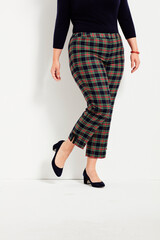 Red and black checkered pants for women’s paired with black full sleeve top and black heels with...