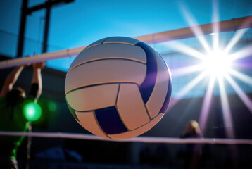 volleyball suspended in mid-air momentarily above the net during a game practice.