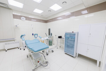 A bright and sterile examination room filled with medical chairs and various types of equipment for patient care