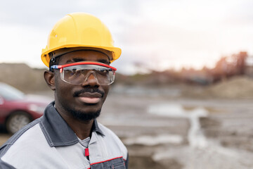 Portrait worker African man surveying engineer in sand quarry ore mining site