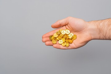 Wealth in Your Hands: Golden Coins Spilling from Hand Conceptualizing Abundance and Prosperity