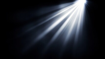 Obraz premium Bright beams of light radiate from a central point in a dark environment, creating a dramatic effect