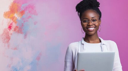 Smiling young african black ethnic woman student holding laptop computer in hands looking at camera isolated on lilac violet mauve studio background, portrait. Remote job and online learning concept.
