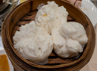 Steamed BBQ pork buns served in a bamboo steamer. A popular Cantonese Dim Sum dish in Hong Kong and Southern China.