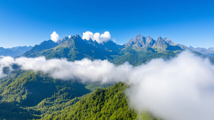 Naklejka premium Mountain Peaks Above Clouds in a Green Valley