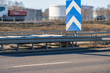traffic safety barrier with arrow sign on highway.