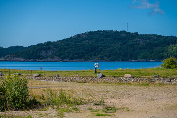Rescue bouy by a canal and a beach.
