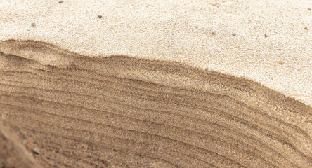Distinct horizontal layers of wet sand. Natural photography