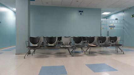 Waiting room with no one in a health center with corridors deserted of people
