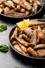 Crispy fried sardines with herbs and lemon. Healthy mediterranean food