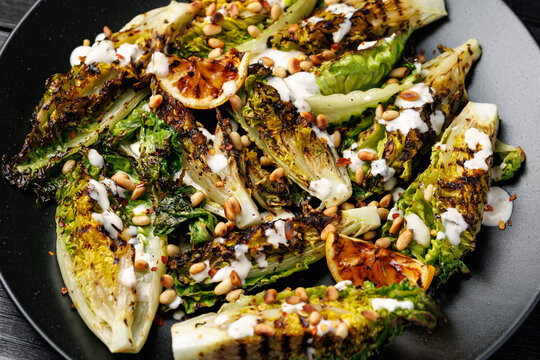 Grilled little gem lettuce with aioli sauce, roasted pine nuts and chilli flakes. Healthy Low carb side salad