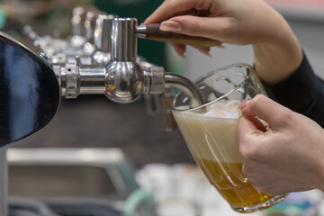 Hands pouring beer into a glass