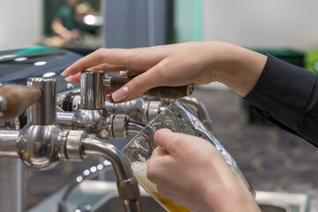 Hands pouring beer into a glass
