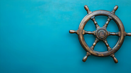 Fototapeta premium Vintage Wooden Ship Wheel On Textured Teal Background With Copy Space For Maritime Theme