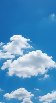 Clear Blue Sky with Fluffy White Clouds on a Sunny Day.