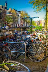 Old bicycle next to canal of Amsterdam