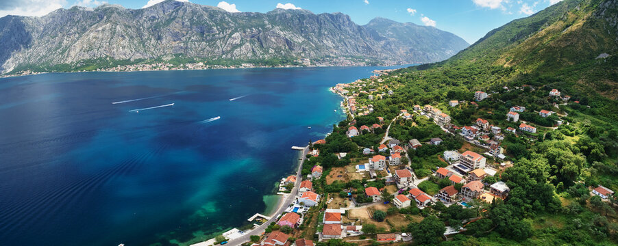 Coast of the resort town of Dobrota on the shore of the Bay of Kotor at the foot of the mountains. Montenegro