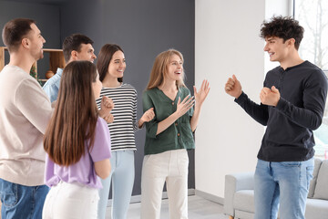 Happy young man talking at group therapy session