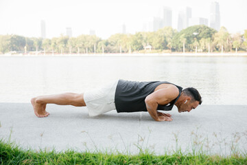 Determined athlete doing push ups outdoors