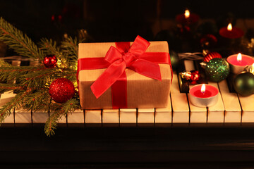 Piano keys with Christmas decor and gift box