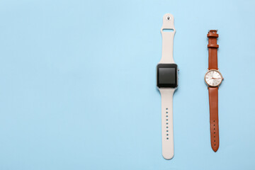 Wristwatch and modern sports tracker on blue background. Concept of evolution