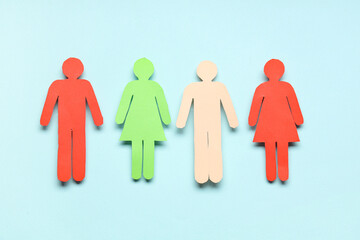 Paper human figures on light blue background
