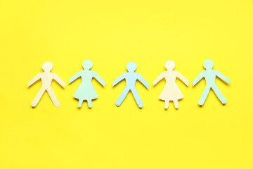 Paper human figures on yellow background