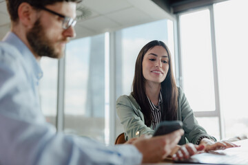 Fototapeta premium Coworkers Collaborating at a Modern Office Setting During a Productive Meeting