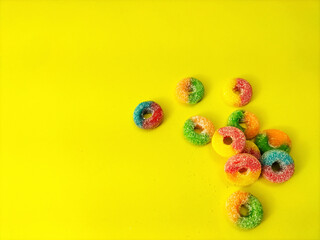 gummy candies on yellow background.