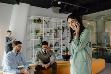 Naklejka premium Team Collaborating in a Modern Office Environment with Positive Communication