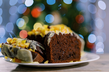 Pieces of traditional Christmas stollen lie on a plate on the table