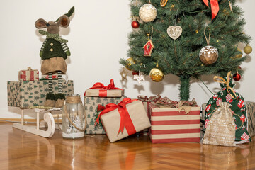 The Christmas tree in the living room, under which are left various gifts in boxes of different colors and sizes.
