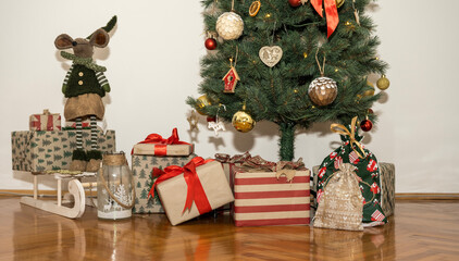 The Christmas tree in the living room, under which are left various gifts in boxes of different colors and sizes.
