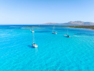Drone view of a sailing yacht. Vacationing people. Summer time for sea travel. Vacation and holidays. The sea lagoon. Seascape from the drone. Wallpaper, postcard, background.
