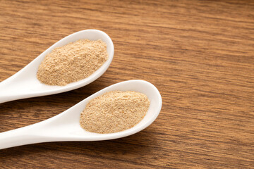 Organic Peruvian maca powder in two spoons - Lepidium meyenii.