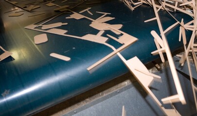 Cardboard industry. Producing cardboard in a factory. Waste at conveyor belt.