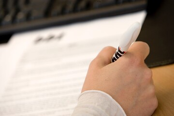 At the office. Administration office. Hand with pencil writing.