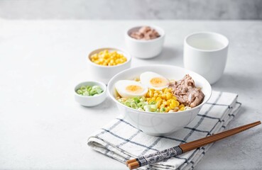 Ramen noodles with pollock liver, corn and scallions in a bowl
