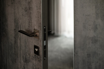 Modern hotel door slightly opened. Warm tones and sleek design. Entrance to perfect for relaxation and travel. Door handle and lock. Security concept 